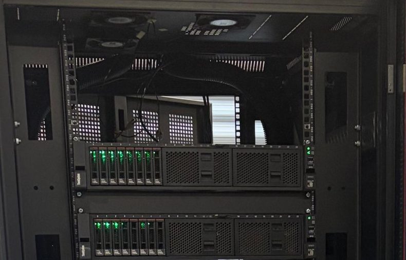 One of our server racks, door open, with servers and networking